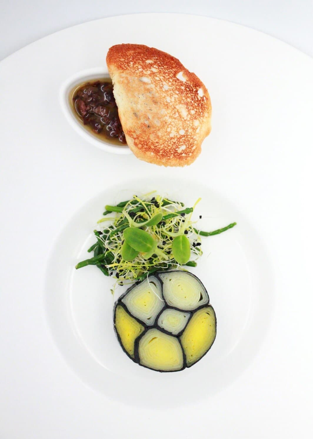 Gallery_Ecole_Ducasse_Iodic_leeks_black_olives_and_anchovies_condiment_Mark_Guillain-Williams_c_Solene_Folatre